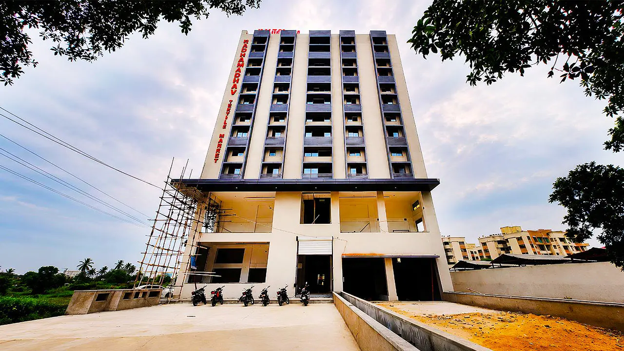 Front view of Radha Madhav Textile Market, a modern multi storey wholesale textile market building in Surat, Gujarat.