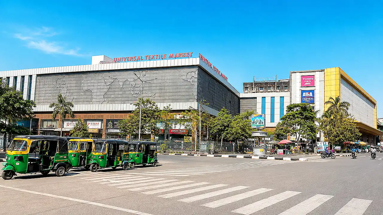 Front view of Universal Textile Market on Ring Road, Surat, a wholesale textile market known for designer fabrics, raw cloth, embroidery materials, and garment accessories.