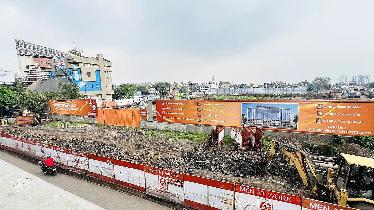 Upcoming textile market construction site on Surat Ring Road with JCB machinery