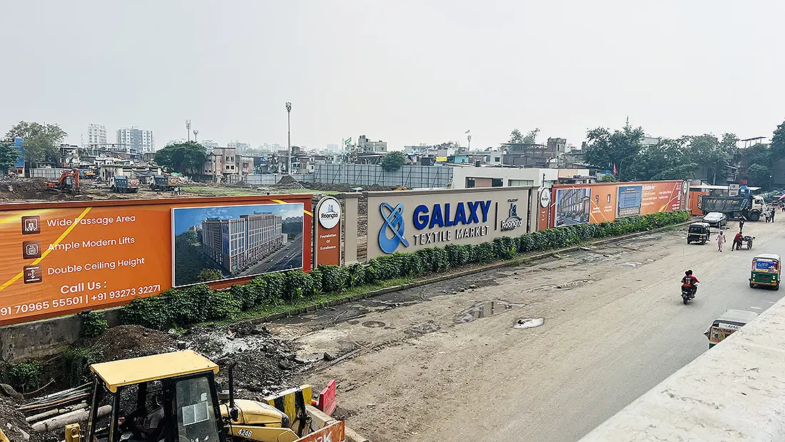 Galaxy Textile Market signboard and construction site along Ring Road in Surat